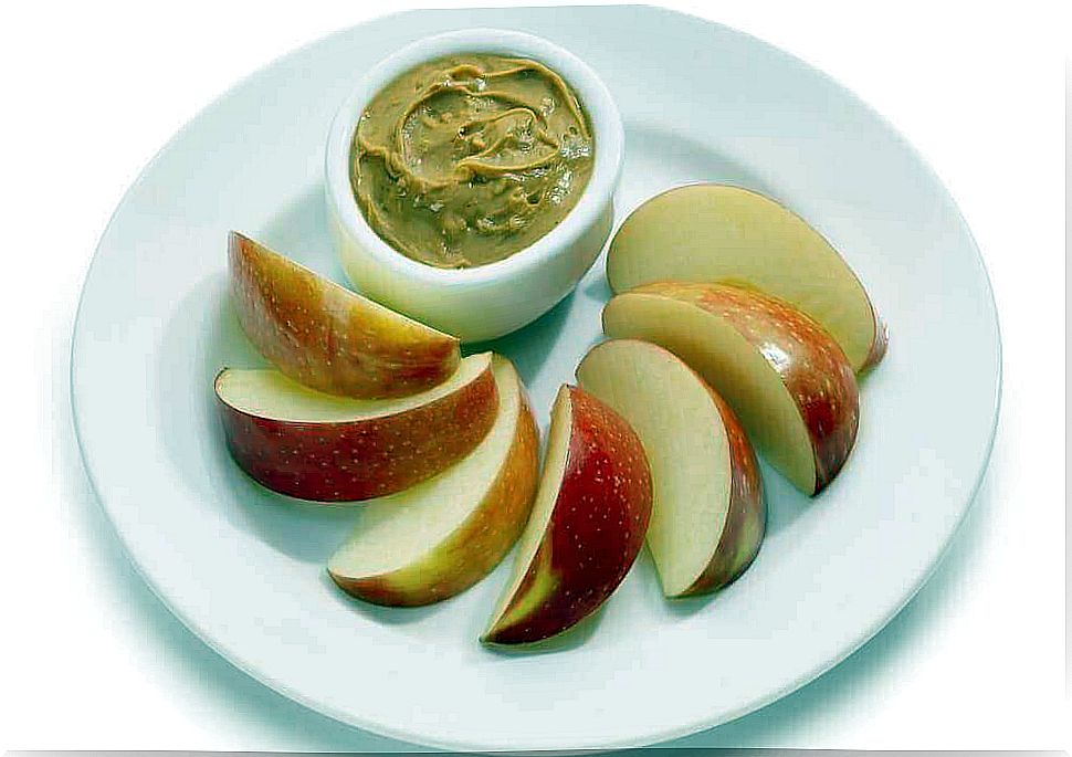 Plate with apple slices and a bowl of peanut butter