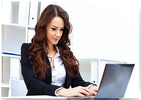 Woman sitting in front of her laptop, because sitting too much is also one of those unhealthy habits