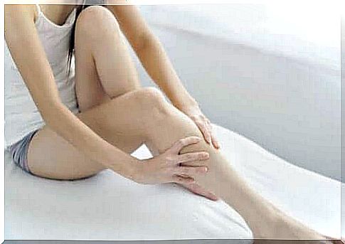 Woman massaging her legs