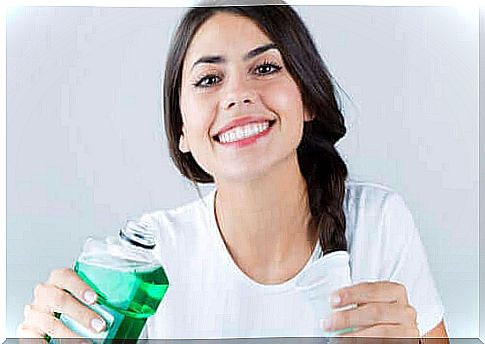 Woman with a bottle of mouthwash