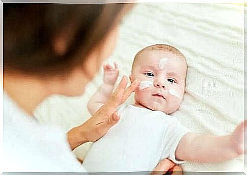 A baby with cream on the face