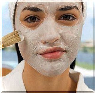 Woman applies skin mask