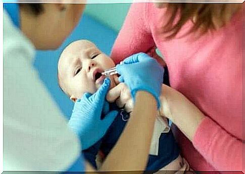 A baby receiving an oral polio vaccine