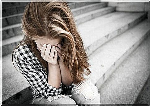 Teenage girl with hands in front of the face