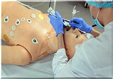 Doctor practicing intubation on a doll