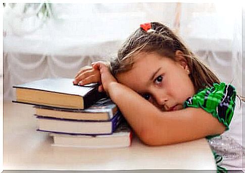 girl hangs tired on her books