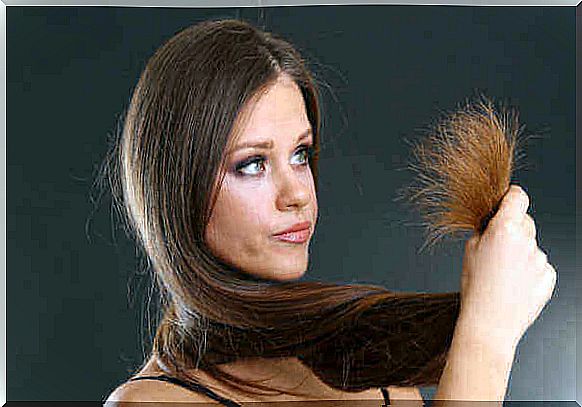 woman looking at her dry hair