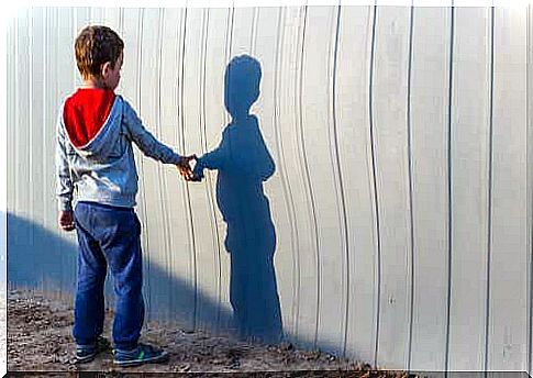 Child looks at his shadow