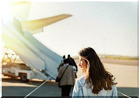 A woman getting on a plane